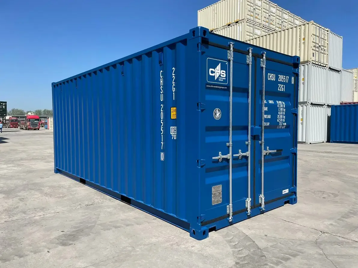 A single blue shipping container standing in a yard, with stacks of more containers behind it